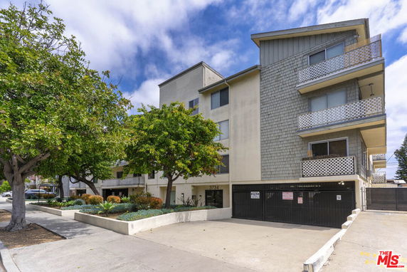 Front view of a multi-story apartment building with balconies.