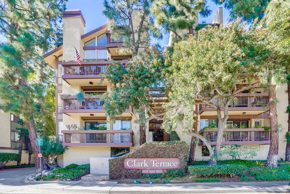 Front view of a multi-story residential building with balconies.
