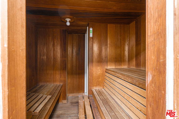 Interior view of a wooden sauna room with benches.
