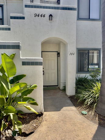 Front view of a building with an arched entrance and house number 9444.