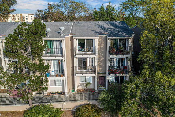 Front view of a multi-story apartment building with balconies.