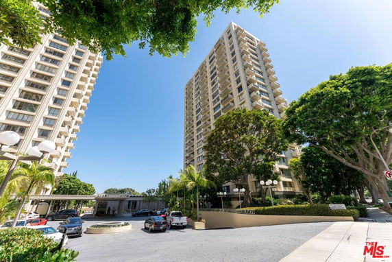 Front view of tall residential buildings with multiple balconies.