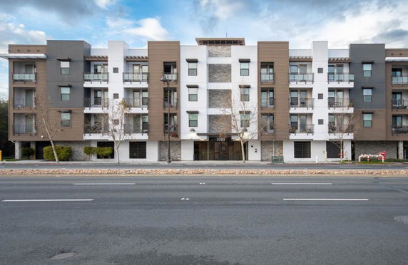 Front view of a multi-story residential building with modern design elements.