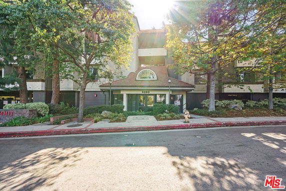Front view of a multi-story building with a central entrance.