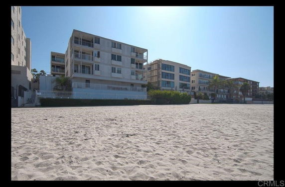 Front view of a multi-story beachfront building.