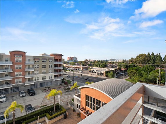 Panoramic view from a building balcony showing surrounding streets and buildings.