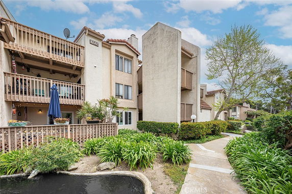 Front view of a multi-story apartment building with balconies.