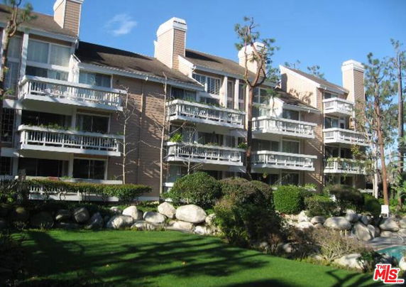 Front view of a multi-story residential building with balconies.