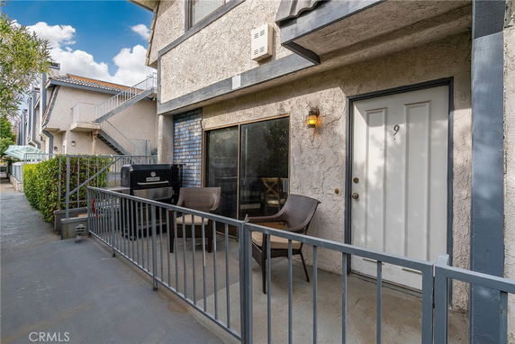 Front view of a building entrance with a small patio area.