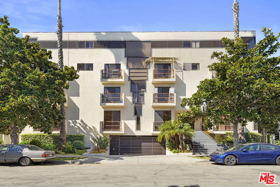 Front view of a multi-story residential building with balconies.