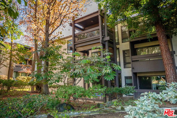 Front view of a multi-story apartment building with balconies.