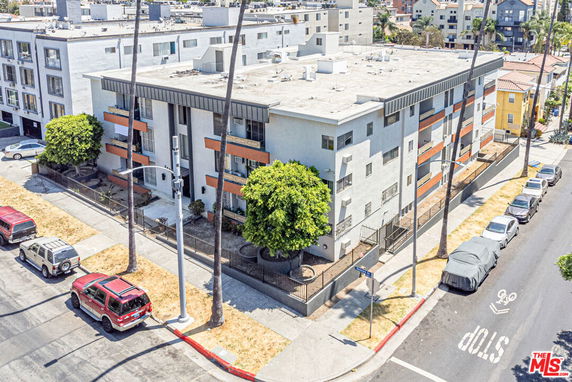 Front view of a multi-story apartment building with balconies.