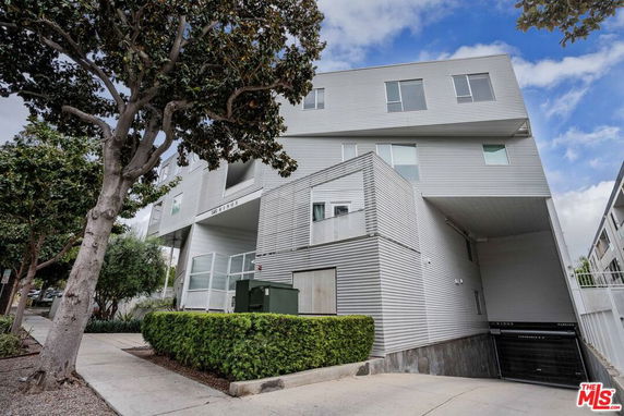 Front view of a modern multi-story building with a unique architectural design.
