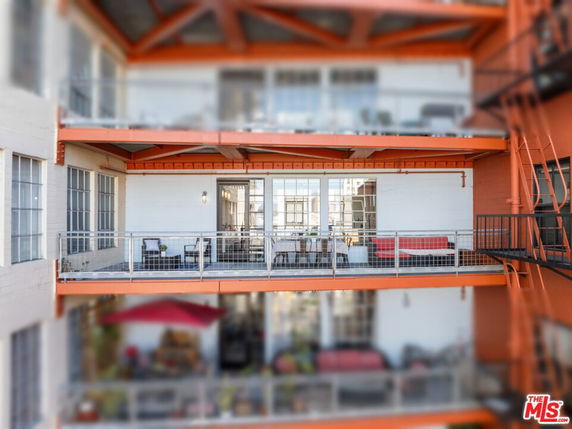 Exterior view of a building with multiple balconies and large windows.