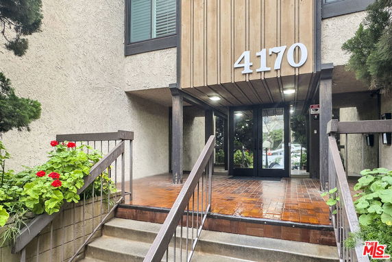 Front view of a building entrance with steps and large number 4170 displayed above the door.