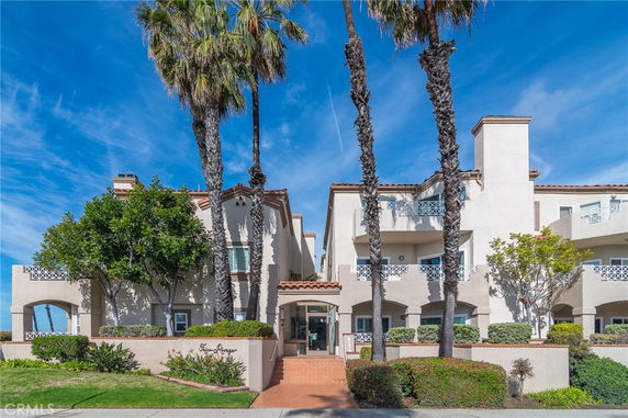 Front view of a multi-story residential building with balconies.