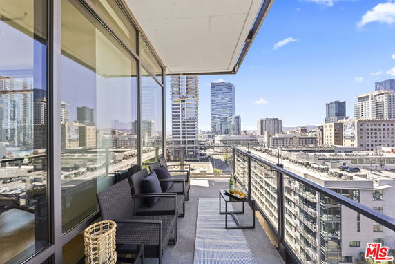 Balcony view with cityscape from a high-rise building.