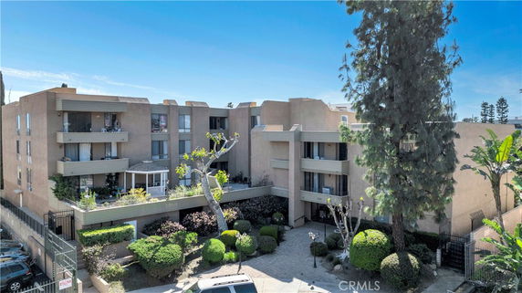 Front view of a multi-story apartment building with balconies.