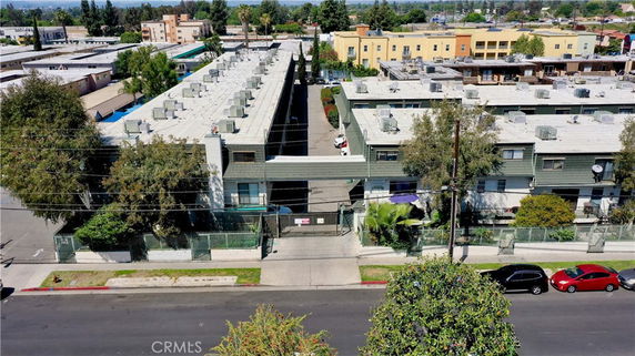 Aerial view of a multi-story apartment complex with flat roofs and multiple units.