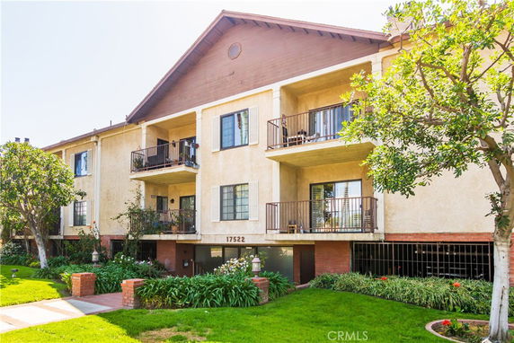 Front view of a multi-story residential building with balconies.