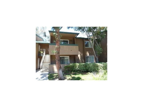 Front view of a two-story house with stairs leading to the upper level.