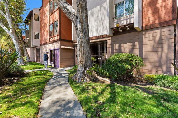 Front view of a multi-story building with a pathway leading to the entrance.