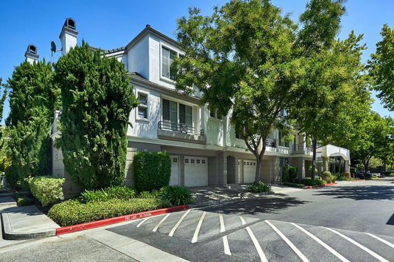 Front view of a multi-story residential building with garages.