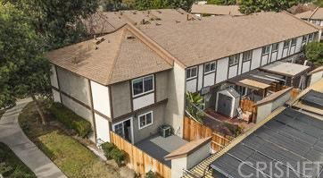 Aerial view of a two-story building with a beige and brown exterior.