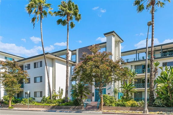 Front view of a multi-story residential building with balconies.