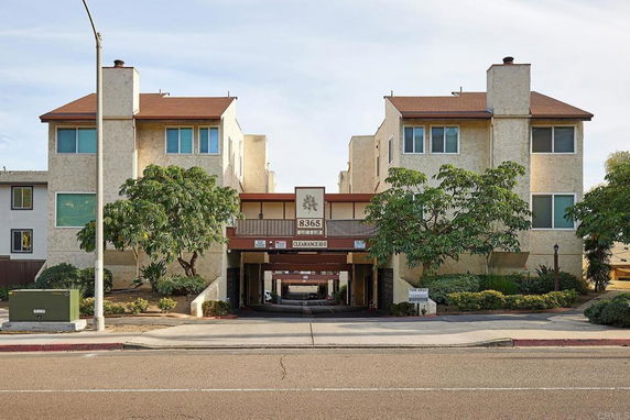 Front view of a multi-story residential building with an entrance.
