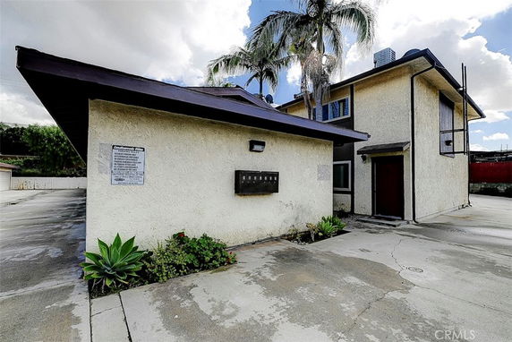 Front view of a two-story building with stucco exterior and flat roof.