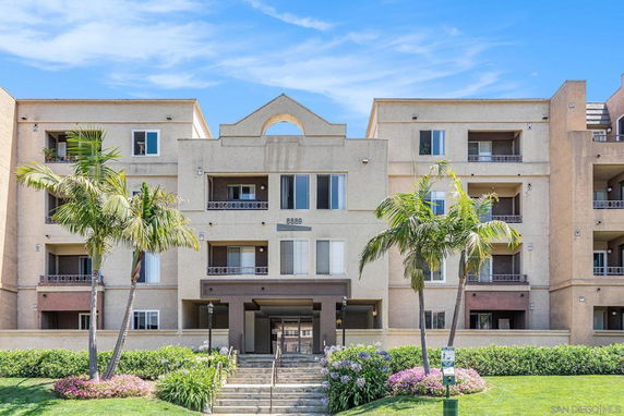 Front view of a multi-story apartment building with balconies.