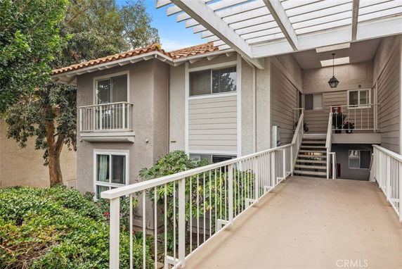 Front view of a multi-story residential building with a walkway.