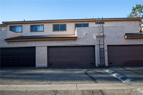 Front view of a multi-story building with multiple garage doors.