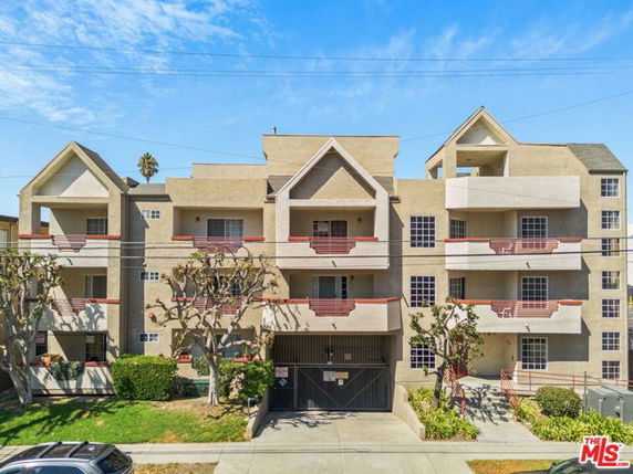 Front view of a multi-story apartment building with balconies.