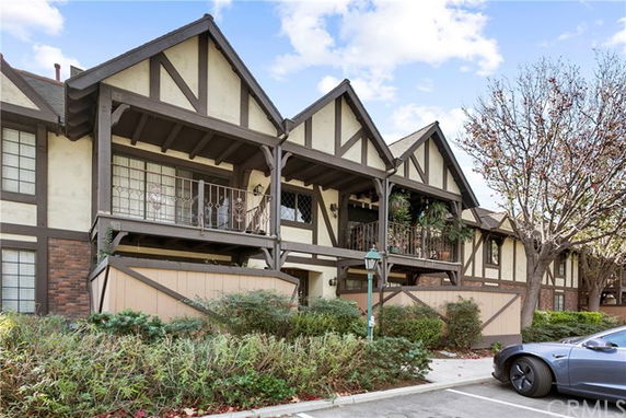Front view of a two-story building with Tudor-style architecture and balconies.