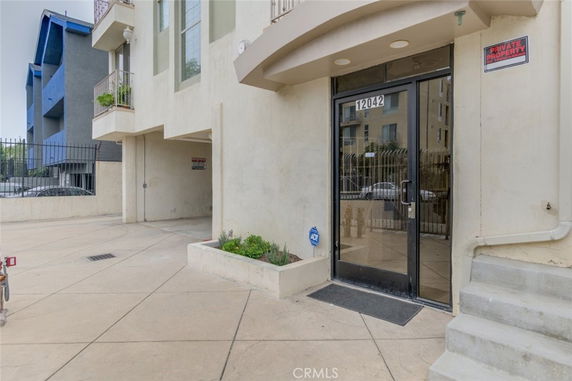 Entrance view of a building with glass doors and numbered signage.