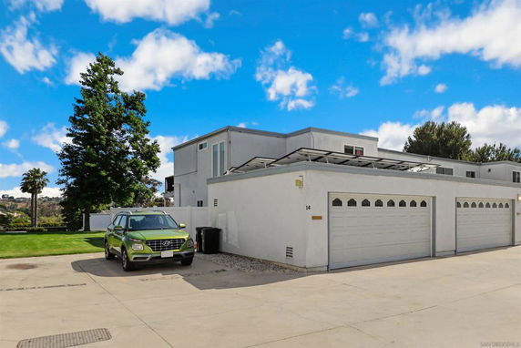 Front view of a two-story house with a three-car garage.