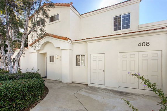 Front view of a two-story house with a garage.