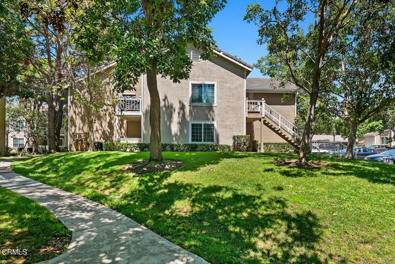 Front view of a two-story residential building with external staircase.