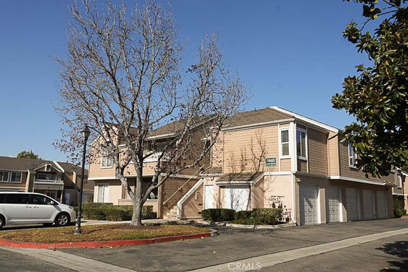 Front view of a two-story residential building with multiple garages.