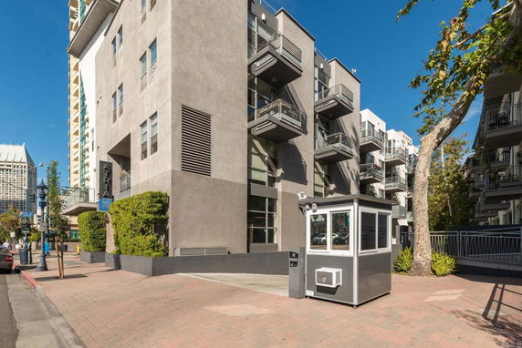 Front view of a modern multi-story apartment building with balconies.