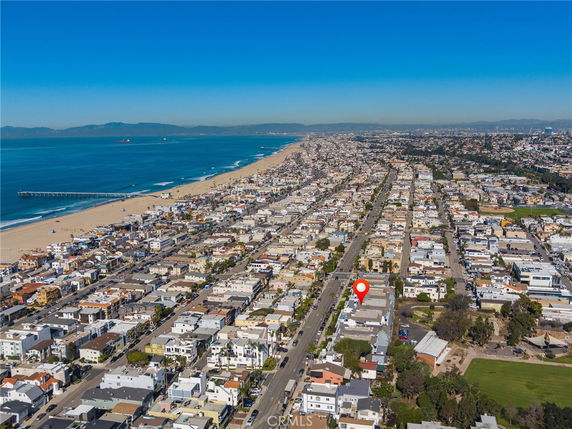 Panoramic view of a coastal city with a stretch of beach and ocean.