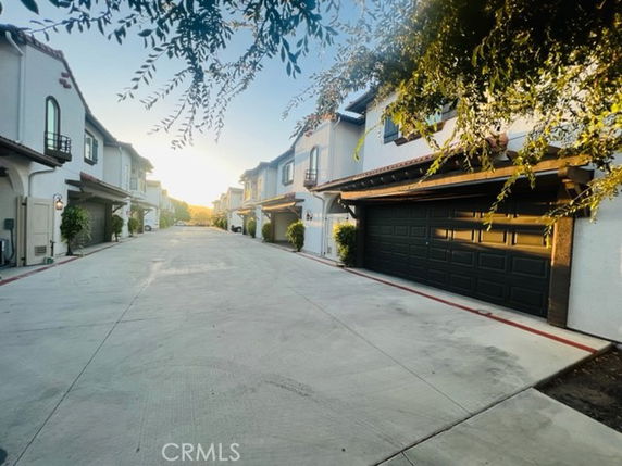 Street view of modern two-story houses with garages.
