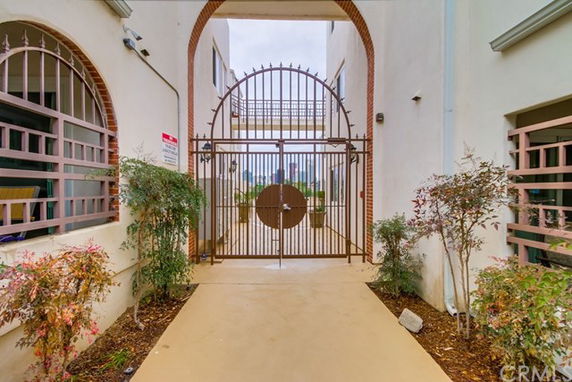 Front view of a building entrance with an iron gate and archway.