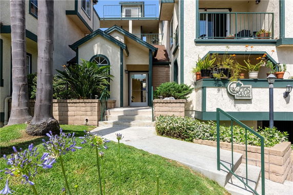 Front view of a residential building with a small landscaped entrance.
