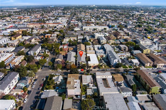 Aerial panoramic view of a residential neighborhood with a mix of houses and apartment buildings.