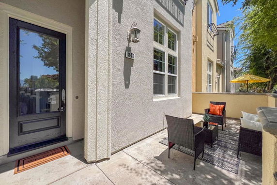 Front view of a house with a small outdoor seating area.
