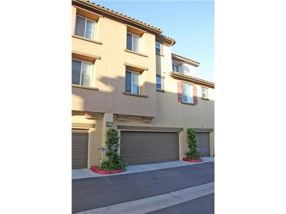 Front view of a multi-story residential building with garages.