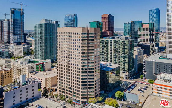 Aerial view of a cityscape with multiple high-rise buildings and skyscrapers.